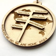 a wooden medal with the names of countries on it and a map in the middle