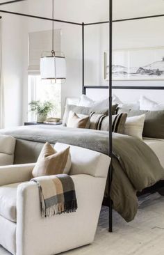 a bedroom with a canopy bed and white furniture