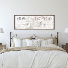 a bed with white sheets and pillows in a bedroom