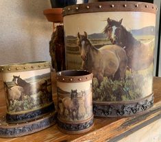 there are three mugs with horses on them sitting on the shelf next to each other