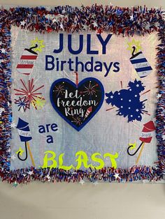 a birthday sign is decorated with red, white and blue streamers in the shape of a heart