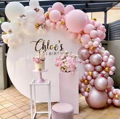 pink and gold balloons are on display in front of a white sign that says,'choe's birthday '