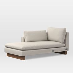 a white couch sitting on top of a wooden frame