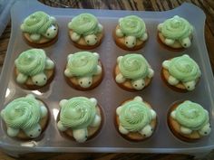 twelve cupcakes with green frosting in the shape of turtles