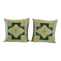 two green and gold pillows on white background