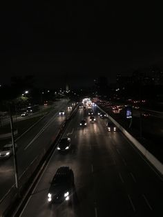 cars are driving down the highway at night in this time lapse photo from an overpass