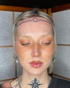 a woman with tattoos on her neck and chest