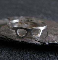 This unique dainty sterling silver ring is handcrafted from 20 gauge sterling silver sheet. The Details ∞ Artisan handmade jewelry ∞ 20 gauge handmade ring band (approx 4.5mm tall at the glasses, 1.2mm band) ∞ Extremely dainty and lightweight ∞ Sterling silver ~ brushed ∞ Choose ring size at checkout ∞ Made to order ∞ Gift box included ∞ Made in the USA There is a charge for the re-sizing of rings, please make sure of your proper ring size before placing your order to avoid a fee if re-sizing is Modern Silver Hypoallergenic Stackable Rings, Modern Hypoallergenic Silver Stackable Rings, Modern Nickel-free Sterling Silver Midi Rings, Handmade Modern Sterling Silver Midi Rings, Modern Handmade Sterling Silver Midi Rings, Modern Handmade Stackable Rings For Anniversary, Modern Handmade Silver Midi Rings, Artisan Jewelry Handmade, Prescott Az