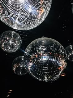 several disco balls hanging from the ceiling