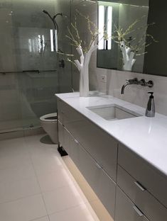 a bathroom with two sinks and a large mirror