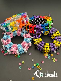 the beads are all different colors and sizes on the table next to each other,