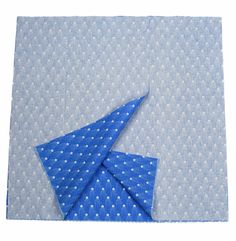 an origami style piece of fabric with blue and white designs