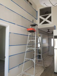 a ladder is being used to paint the walls