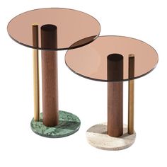 two round tables with wooden bases and glass tops, one on top of the other