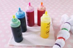 there are many different colored bottles next to each other on the table with polka dots