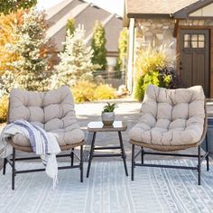 two chairs sitting next to each other on a patio