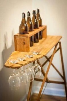 several empty wine glasses are sitting on a wooden shelf