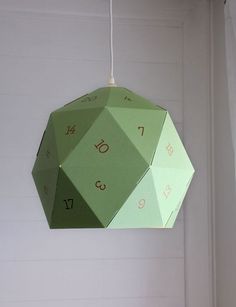 a green hanging ornament with numbers on it in a white walled wall room