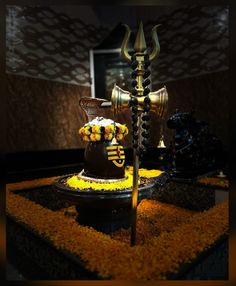 a chocolate cake decorated with yellow and white flowers on top of a black table cloth