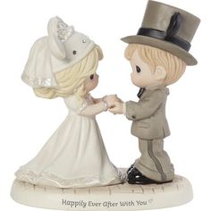 a figurine is holding hands with a little boy in a suit and top hat