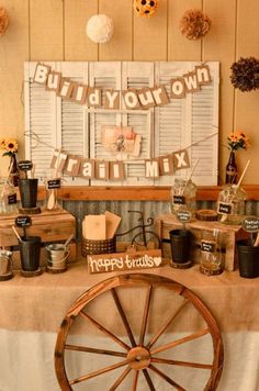 a wagon wheel sits in front of a table with decorations