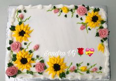 a cake decorated with sunflowers and roses