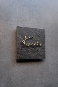 a wooden name plate with the word kaneka on it