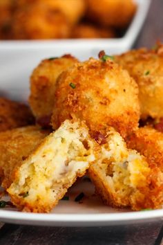 some fried food on a white plate with other dishes in the backgroung