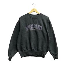 "Code : w/7 Vintage Outer Bank North Carolina Embroidered Spellout Logo Print Crewneck Sweatshirt Pullover Jumper Streetwear Grey Sweatshirt Size Small Size on Tag :  S Details Measurement  Arm Pit to Arm Pit : 23\"inches Back Collar to Hem : 25\"inches Condition :  Great Vintage Condition.❌NO HOLES AND NO STAIN❌.Please refer pictures detail.‼️" Gray Crew Neck Top For Campus, Embroidered Long Sleeve College Sweater, Embroidered Long Sleeve Sweater For College, Fall Campus Tops With Embroidered Graphics, College Crew Neck Sweater With Embroidered Graphics, Campus Sweatshirt With Embroidered Graphics, Winter College Tops With Embroidered Logo, Crew Neck Sweater For Campus In Winter, Winter Crew Neck Sweater For Campus