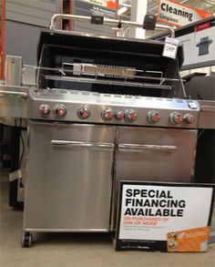 a stainless steel oven with red knobs on it's sides and a sign that says special finance available