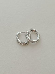 Silver Textured Small Huggie Hoop Earrings. ✦ Material : High quality brass with rhodium plating ✦ Dimensions : W14.5mm X L14mm X T3mm ✦ This is Etsy exclusive item. ~ Jewellery Care 1. Keep your jewellery away from chemicals such as perfume, makeup, sun-cream, body lotion, and nail polish remover.   2. Keep your jewellery away from water where possible. Remove it before swimming, showering, exercising, etc. 3. Try not to rub your jewellery, and remember to remove it before sleeping. 4. Gently w Small Silver Stud Earrings, Mini Hoop Earrings Silver, Silver Huggie Hoop Earrings, Huggie Hoop Earrings Silver, Small Hoop Earrings Silver, Silver Small Hoop Earrings, Silver Ear Rings, Silver Huggies, Silver Earrings Aesthetic