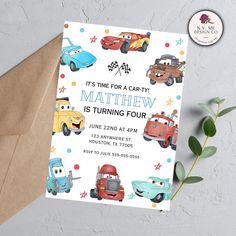 a birthday card with cars and stars on it, sitting next to a brown envelope