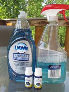 two bottles of dish soap and one bottle of mouthwash are sitting on a table