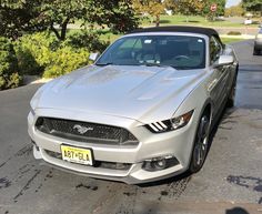 a silver sports car parked in a parking lot