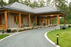 a large house with lots of windows and wood trimmings on the front porch