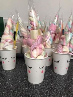 several cups filled with candy and marshmallows