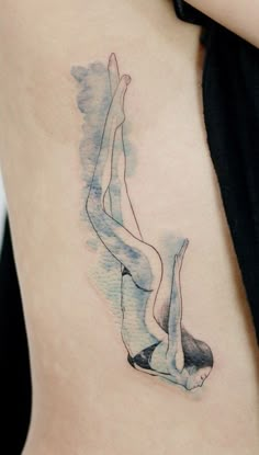 a woman's back with a watercolor painting style tattoo on her left side