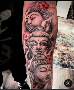 a person with a tattoo on their arm and some buddhas in the middle of it