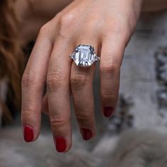 a woman's hand with a diamond ring on it