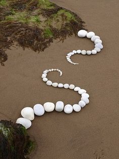 the word love spelled out with rocks in the sand