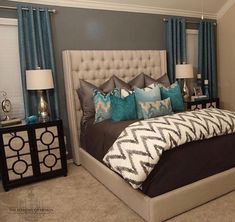 a bedroom with blue and gray decor in it