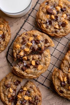 chocolate chip cookies cooling on a rack next to a glass of milk