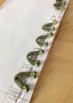 some scissors are laying on top of a piece of paper with measuring lines in the background