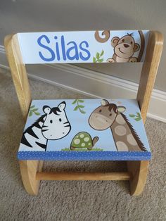 a child's personalized wooden chair with an animal theme