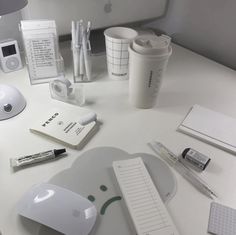 an apple computer mouse, keyboard and other items on a desk