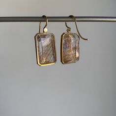 Naturally formed golden rutiles dance within these breathtaking emerald cut quartz stones. 18k yellow gold Rutilated quartz 9/16" x 3/4" Earrings hang 1 3/16" from the ear Each earring weighs 4.7g Newport Ri, Study Style, Arts And Crafts Movement, Quartz Earrings, Clothes Horse, Rutilated Quartz, Quartz Stone, Emerald Cut, Jewelry Art