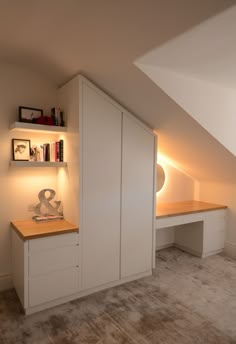 an attic bedroom with built in bookshelves and shelves