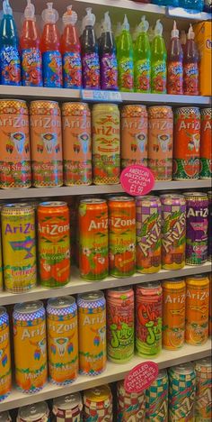 many different types of sodas are on display in a grocery store, and one is labeled arizona