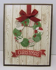 a christmas card with a wreath on it