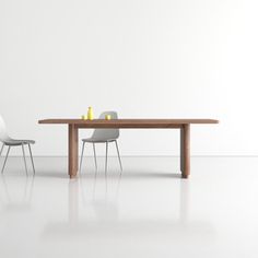 a dining table with two chairs next to it